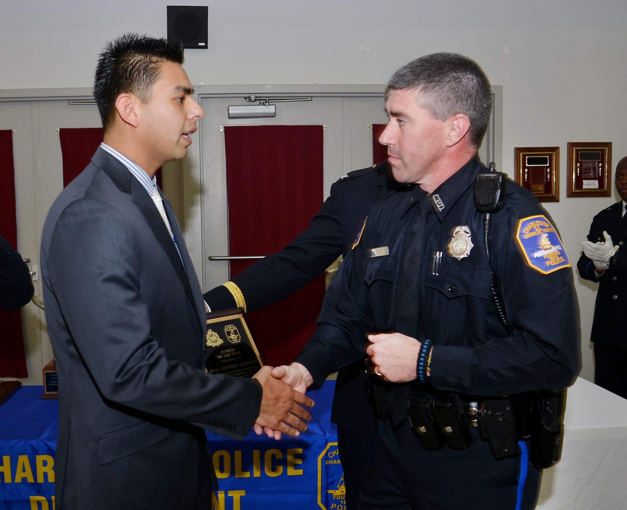 Officer Wes Foster, right, with the Charleston Police Department thanks former Staff Sgt. Jeffery Aldana following a recognition and awards ceremony for saving his life. Courtesy photo/JIM MOSSMAN