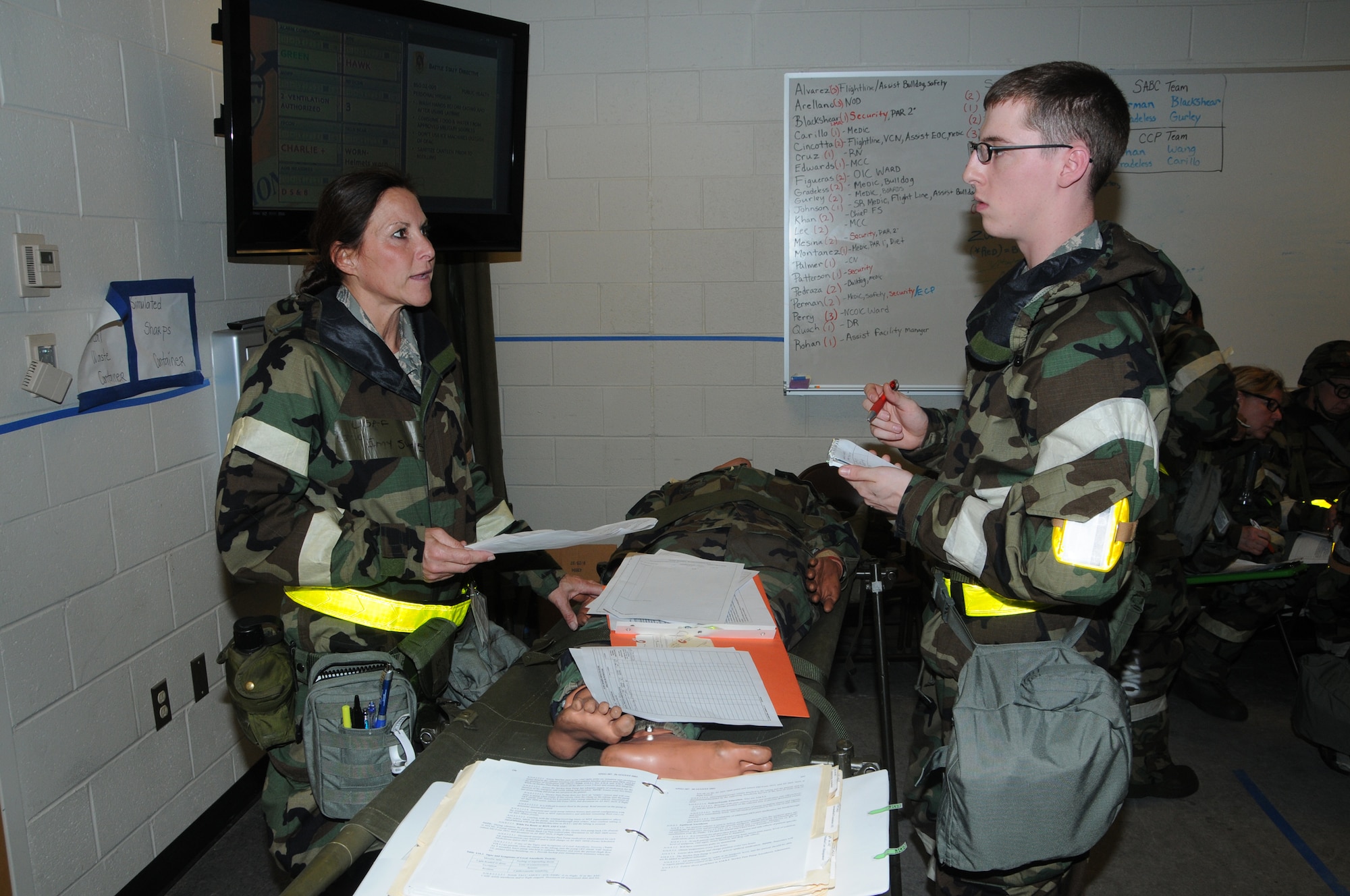 WRIGHT-PATTERSON AIR FORCE BASE, Ohio – Lt. Col. Amy Swets and Senior Airman Jonathan Reshkus, both from the 445th Aeromedical Staging Squadron, collaborate over a mock trauma patient's condition during an exercise scenario while deployed to the Trent Lott Combat Readiness Training Center in Gulfport, Miss., Jan. 30, during the wing’s 2013 operational readiness inspection conducted Jan. 28 through Feb. 1. (U.S. Air Force Photo/Tech. Sgt. Anthony G. Springer)