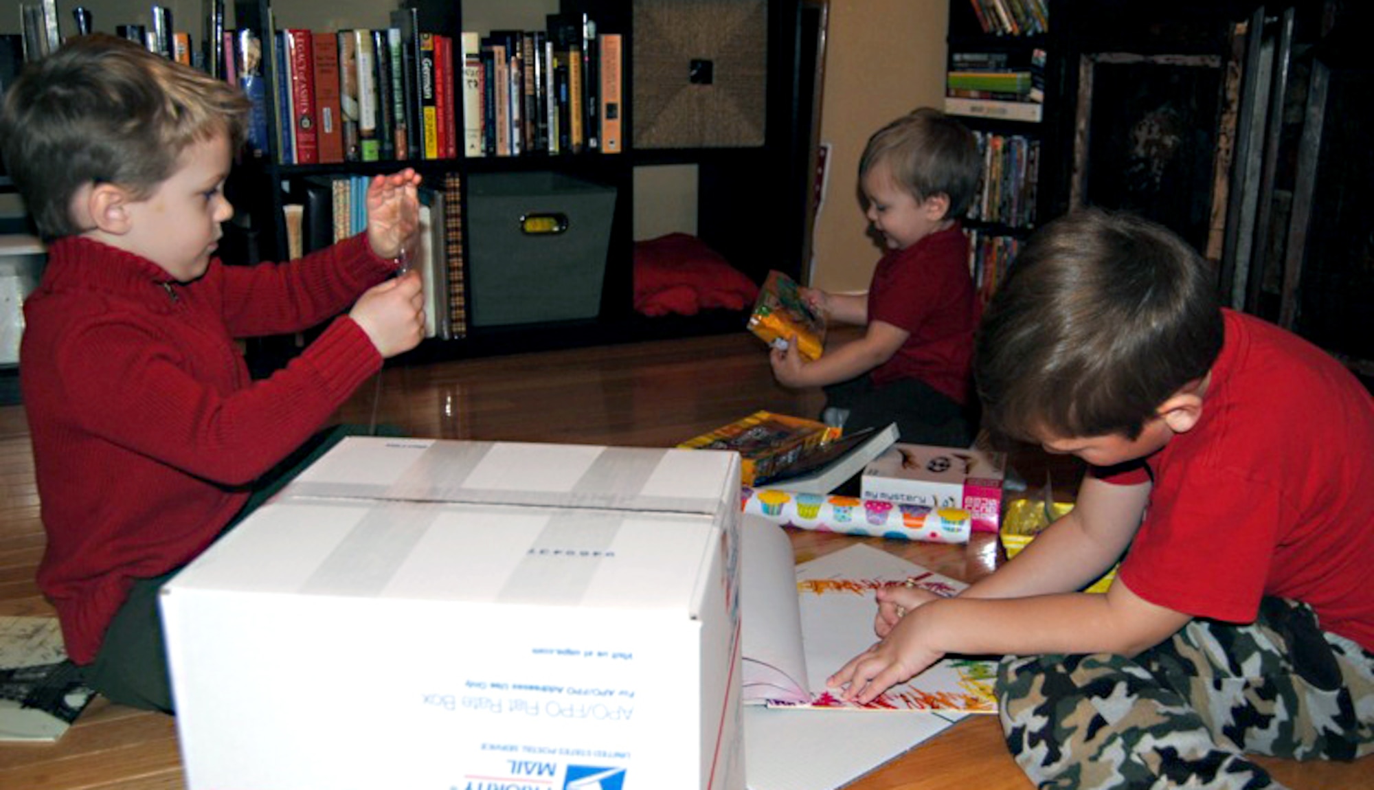 From left, Harrison, Levi and Gammon Arnett put together a Valentine’s Day care package for their father, U.S. Army Capt. Sam Arnett, at their home in Newport News, Va., Feb. 2, 2013.  Their father is currently deployed to Camp Buehring, Kuwait. (Courtesy photo/Released)