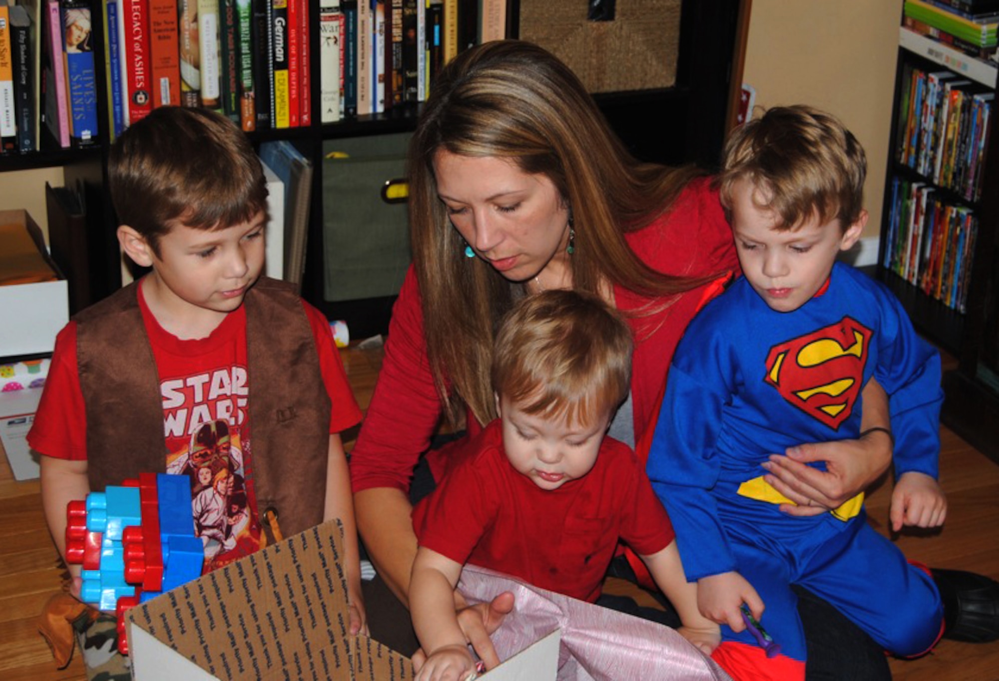 From left, Gammon, Sara Jane, Levi and Harrison Arnett put together a Valentine’s Day care package for their father and husband, U.S. Army Capt. Sam Arnett, at their home in Newport News, Va., Feb. 2, 2013. With her husband currently deployed to Camp Buehring, Kuwait, Mrs. Arnett said sending packages is imperative in order to keep strong bonds during separations. (Courtesy photo/Released)