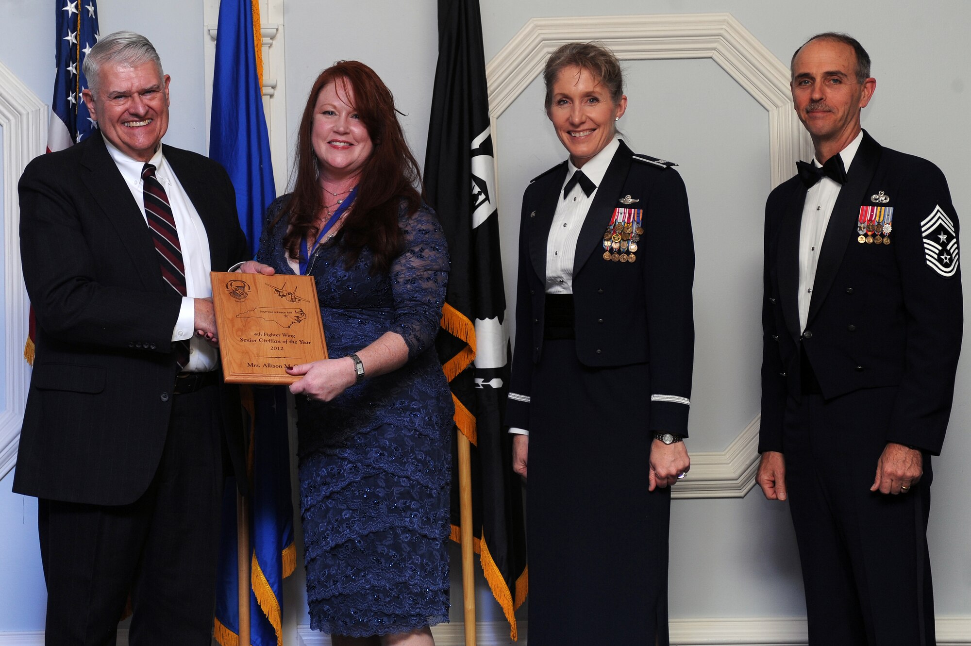 Ms. Allison McQueen, 4th Medical Operations Squadron demand reduction program manager, receives the 4th Fighter Wing Senior Civilian of the Year award from retired Brig. Gen. Lawrence Huggins, during the annual awards banquet on Seymour Johnson Air Force Base, N.C., Feb. 2, 2013. (U.S. Air Force photo/Airman 1st Class John Nieves Camacho/Released) 