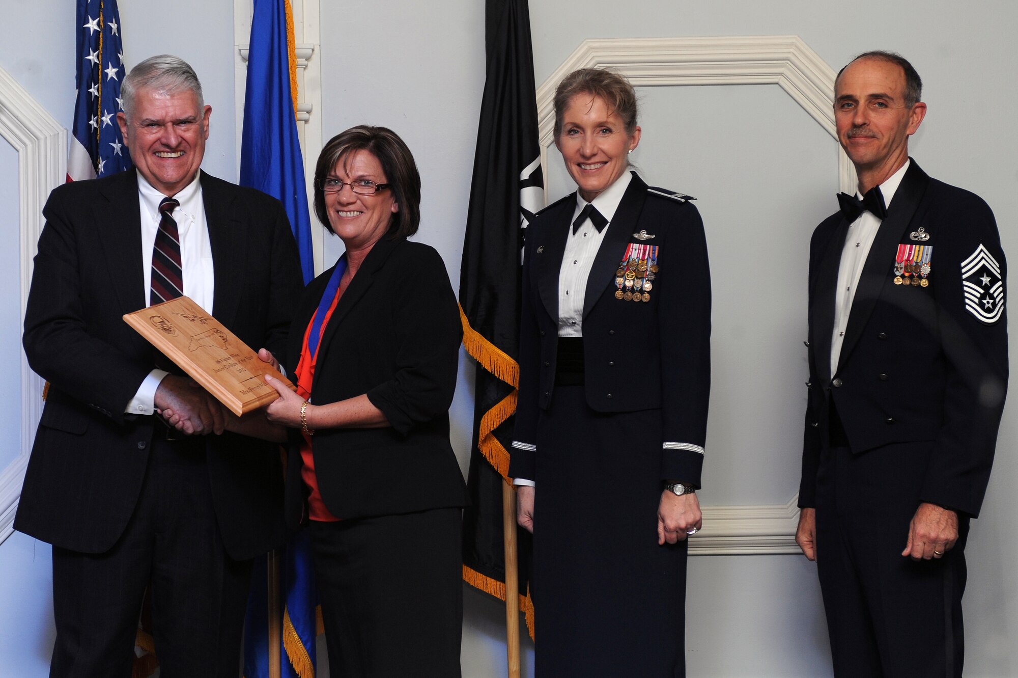 Ms. Penny McLauchlin, 4th Civil Engineer Squadron supply technician, receives the 4th Fighter Wing Junior Civilian of the Year award from retired Brig. Gen. Lawrence Huggins, during the annual awards banquet on Seymour Johnson Air Force Base, N.C., Feb. 2, 2013. (U.S. Air Force photo/Airman 1st Class John Nieves Camacho/Released)