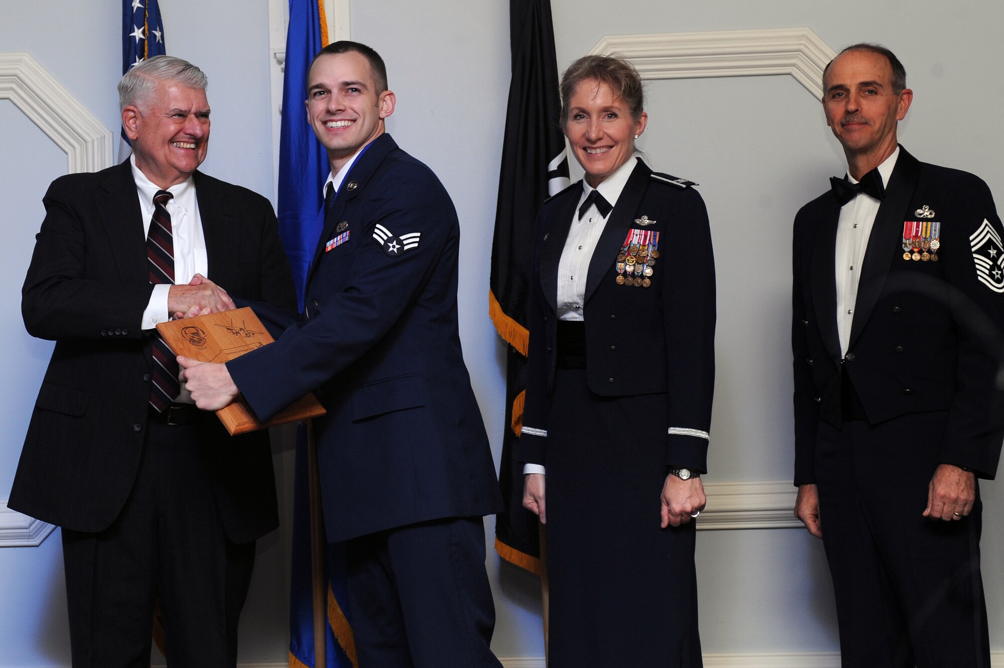 U.S. Air Force Senior Airman Andrew Schirmer, 4th Component Maintenance Squadron aircraft fuel systems journeyman, receives the 4th Fighter Wing Honor Guard Member of the Year award from retired Brig. Gen. Lawrence Huggins, during the annual awards banquet on Seymour Johnson Air Force Base, N.C., Feb. 2, 2013. (U.S. Air Force photo/Airman 1st Class John Nieves Camacho/Released)
