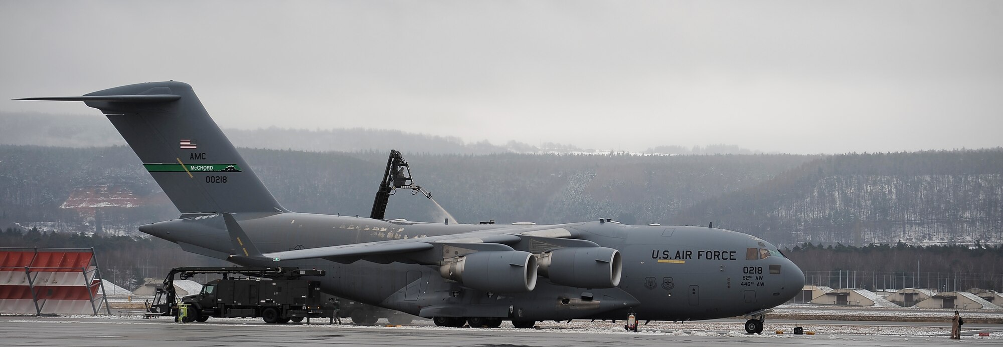 Airmen from the 721st Aircraft Maintenance Squadron de-ice a C-17 Globemaster III on Ramstein Air Base, Germany, Feb. 6, 2013. The Airmen from the 721st AMXS ensured the safety of the aircraft by eliminating potentially hazardous debris. (U.S. Air Force photo/Airman 1st Class Jordan Castelan)