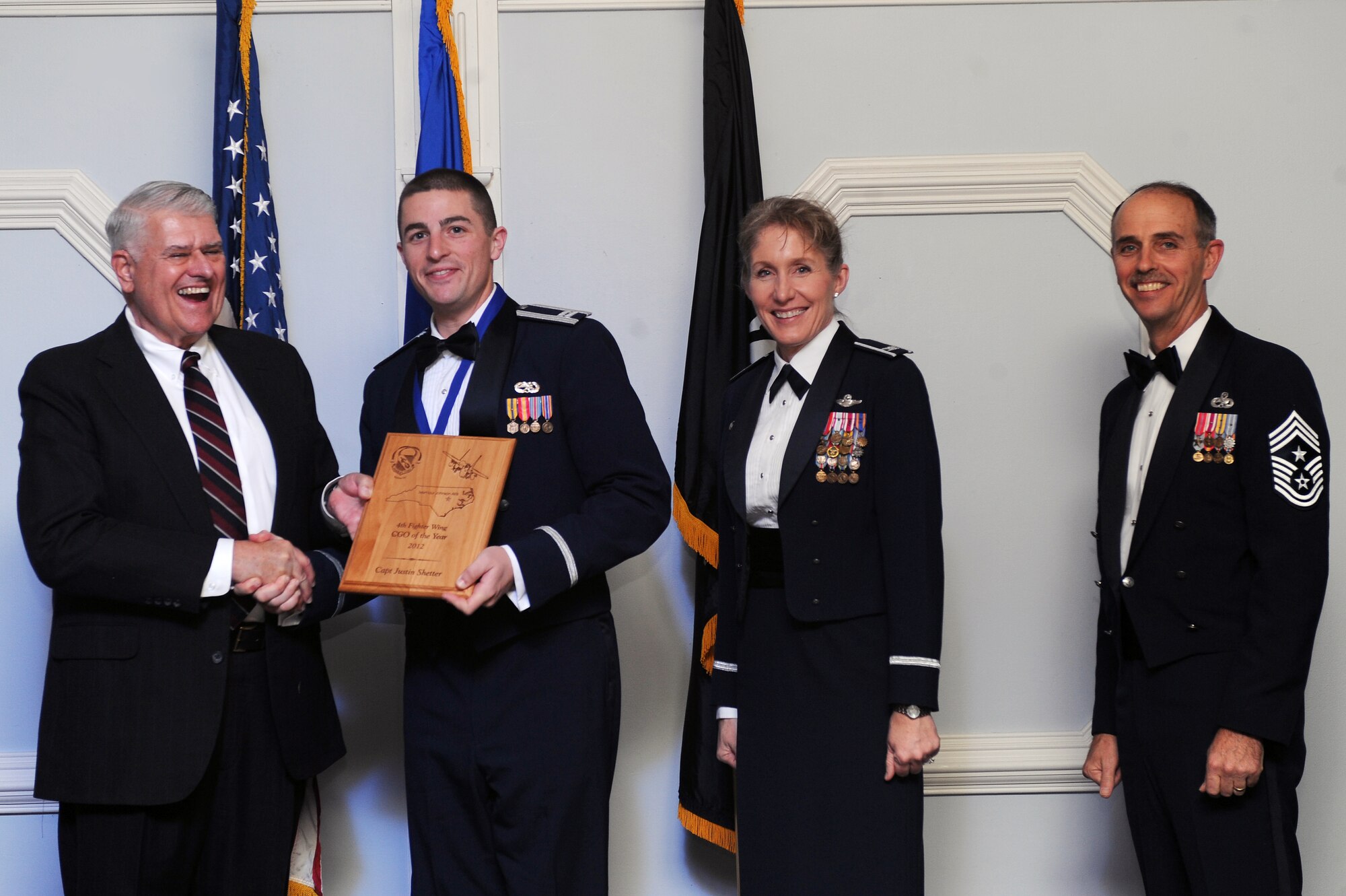 U.S. Air Force Capt. Justin Shetter, 4th Aircraft Maintenance Squadron officer in charge, receives the 4th Fighter Wing Company Grade Officer of the Year award from retired Brig. Gen. Lawrence Huggins, during the annual awards banquet on Seymour Johnson Air Force Base, N.C., Feb. 2, 2013. (U.S. Air Force photo/Airman 1st Class John Nieves Camacho/Released)