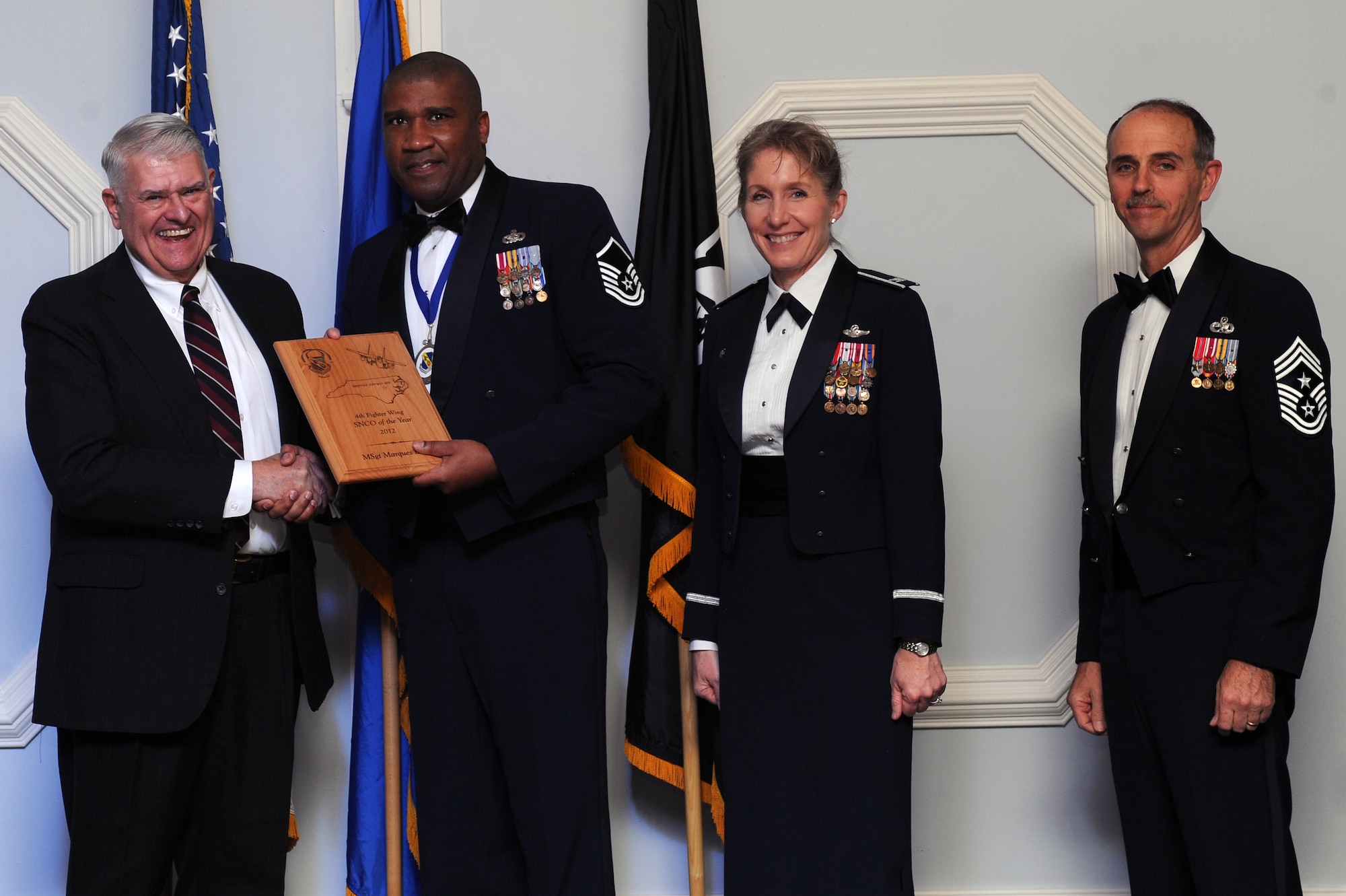 U.S. Air Force Master Sgt. Marques Boyce, 4th Logistics Readiness Squadron fuels operations section chief, receives the 4th Fighter Wing Senior NCO of the Year award from retired Brig. Gen. Lawrence Huggins, during the annual awards banquet on Seymour Johnson Air Force Base, N.C., Feb. 2, 2013. (U.S. Air Force photo/Airman 1st Class John Nieves Camacho/Released)