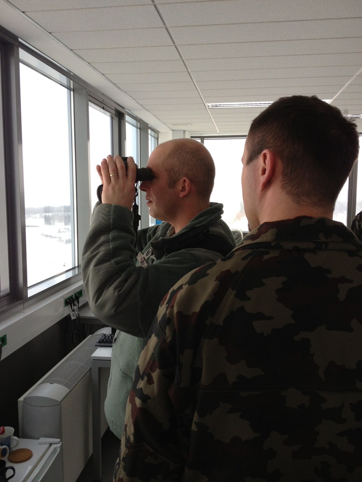 Master Sgt. Jay Peavey, 435th Contingency Response Group air advisor and security superintendent, views the ramp and runway complex from the newly constructed control tower on Cerklje Air Base, Slovenia, Dec. 22, 2012. (courtesy photo)