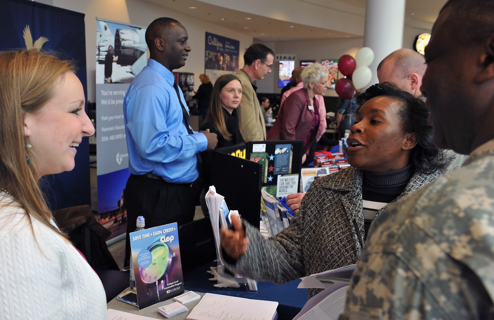 U.S. Army Staff Sgt. Lana Edwards, NCOIC of quality management, consults with individuals working the education fair to better educate herself on future opportunities on Ramstein Air Base, Germany, Jan. 31, 2013. The education office hosted the education fair at the Kaiserslautern Military Community Center to inspire people to get started on their education or to further pursue a degree. (U.S. Air Force photo/Airman 1st Class Dymekre Allen)