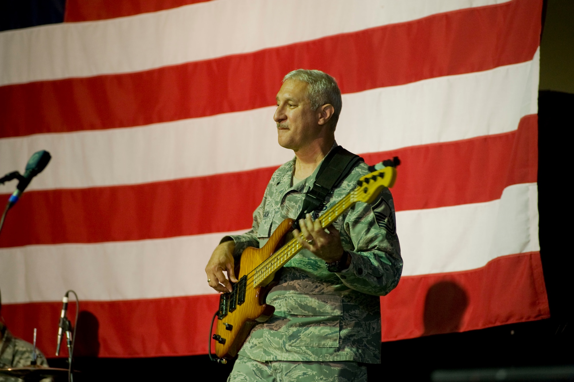 Master Sgt. Doug Tejada, U.S. Air Forces Central Command Band bassist and NCO in charge, performs for U.S. service members at Transit Center at Manas, Kyrgyzstan, Jan. 25, 2013. "Total Force" performed at five different schools to include orphanages, boarding schools, high schools and music schools. (U.S. Air Force photo/Staff Sgt. Stephanie Rubi)