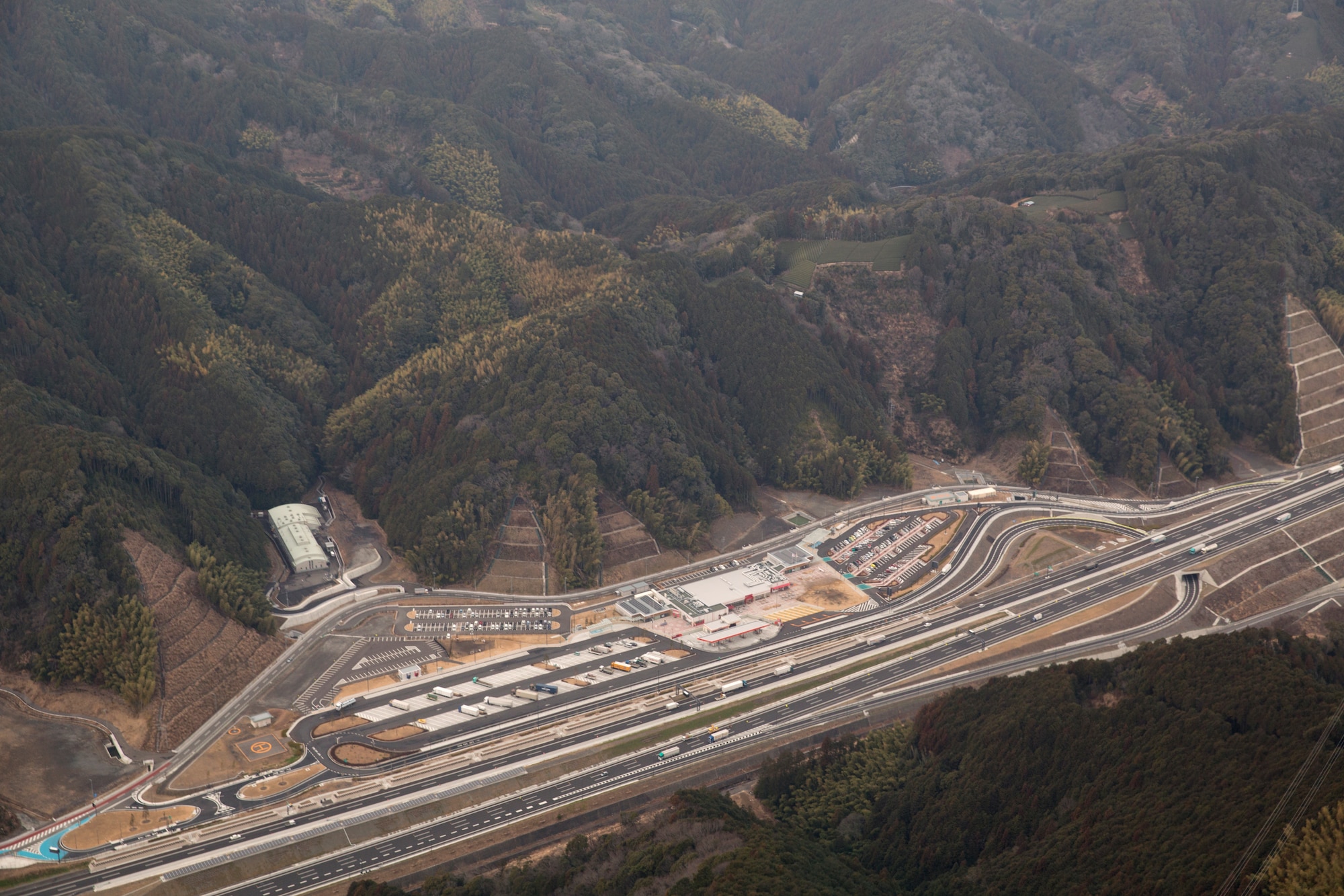 ABOVE SHIZUOKA PREFECTURE, Japan -- Aerial view of a helipad at Enshu Mori-machi Parking Area on the Shin-Tomei Expressway, Shizuoka Prefecture, Feb. 5, 2013. The helipad is designed for use during an emergency response or mass casualty situations. (U.S. Air Force photo by Osakabe Yasuo)