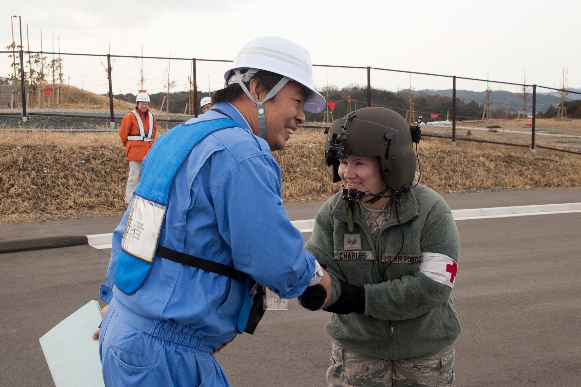 SHIZUOKA PREFECUTRE, Japan -- Staff Sgt. Leslie Charles, 374th Medical Operations Squadron independent duty medical technician, greets a member from the Shizuoka prefectural government after the UH-1N Huey helicopter landed at the Shin-Tomei expressway's service area in Shizuoka Prefecture, Japan, Feb. 5, 2013. (U.S. Air Force photo by Osakabe Yasuo)