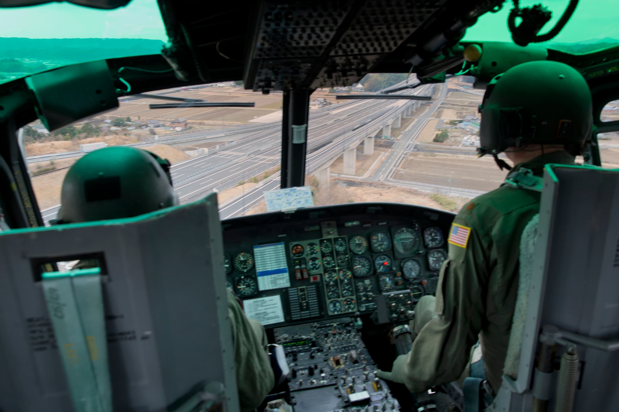 SHIZUOKA PREFECTURE, Japan -- A UH-1N Huey helicopter crew from the 459th Airlift Squadron flies over the Shin-Tomei Expressway in the Shizuoka Prefecture, Japan, during an emergency response aviation help drill, Feb. 5, 2013. The Shizuoka Prefectural Government hosted the drill, which required the practice of using expressway's service area as an emergency landing zone for helicopters. (U.S. Air Force photo by Osakabe Yasuo)