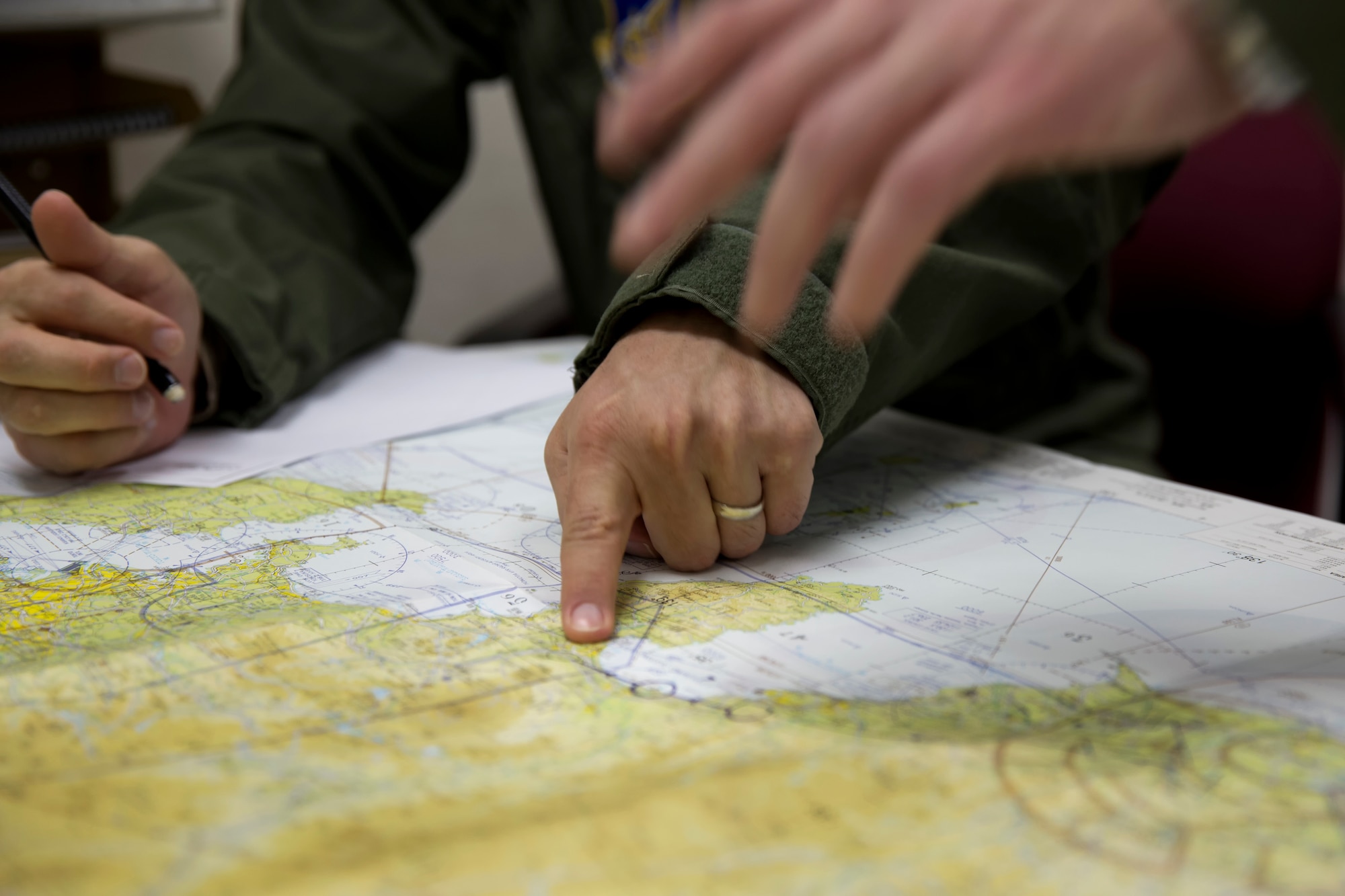 YOKOTA AIR BASE, Japan -- A UH-1 Huey helicopter aircrew from the 459th Airlift Squadron checks their route on a map during a pre-flight briefing, Feb. 5, 2013 at Yokota Air Base, Japan. Airmen from Yokota participated in an emergency response aviation help drill in Shizuoka Prefecture, southwest of Yokota. (U.S. Air Force photo by Osakabe Yasuo)