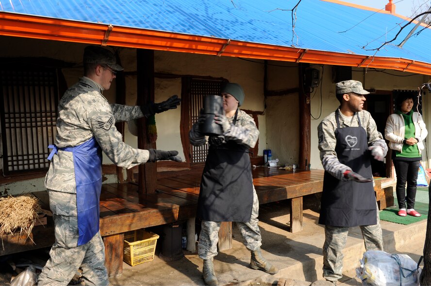 U.S. Air Force personnel move coal briquettes into a resident’s home in Gunsan City, Republic of Korea, Jan. 30, 2013. More than 7,700 pounds of coal were donated to needy families to keep their houses heated, and members of the Wolf Pack delivered the fuel source. (U.S. Air Force photo by Senior Airman Marcus Morris/Released)