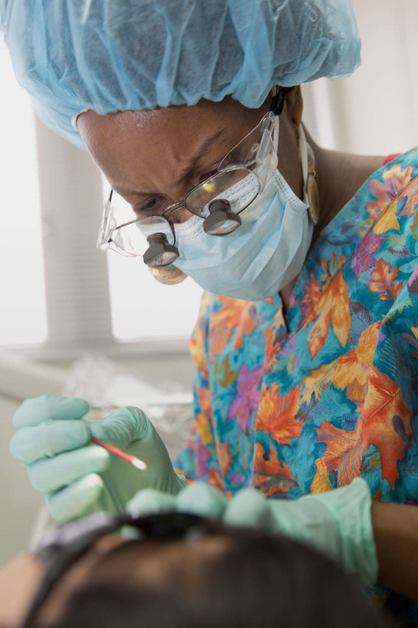 YOKOTA AIR BASE, Japan -- Tanika Davis, 374th Dental Squadron registered dental hygienist, cleans a child's teeth at the Yokota Dental Clinic, Feb. 2, 2013. As part of National Children's Dental Health Month, the 374 DS hosted a walk-in clinic for children, including dental examinations, cleanings and education services. (U.S. Air Force photo by Osakabe Yasuo)