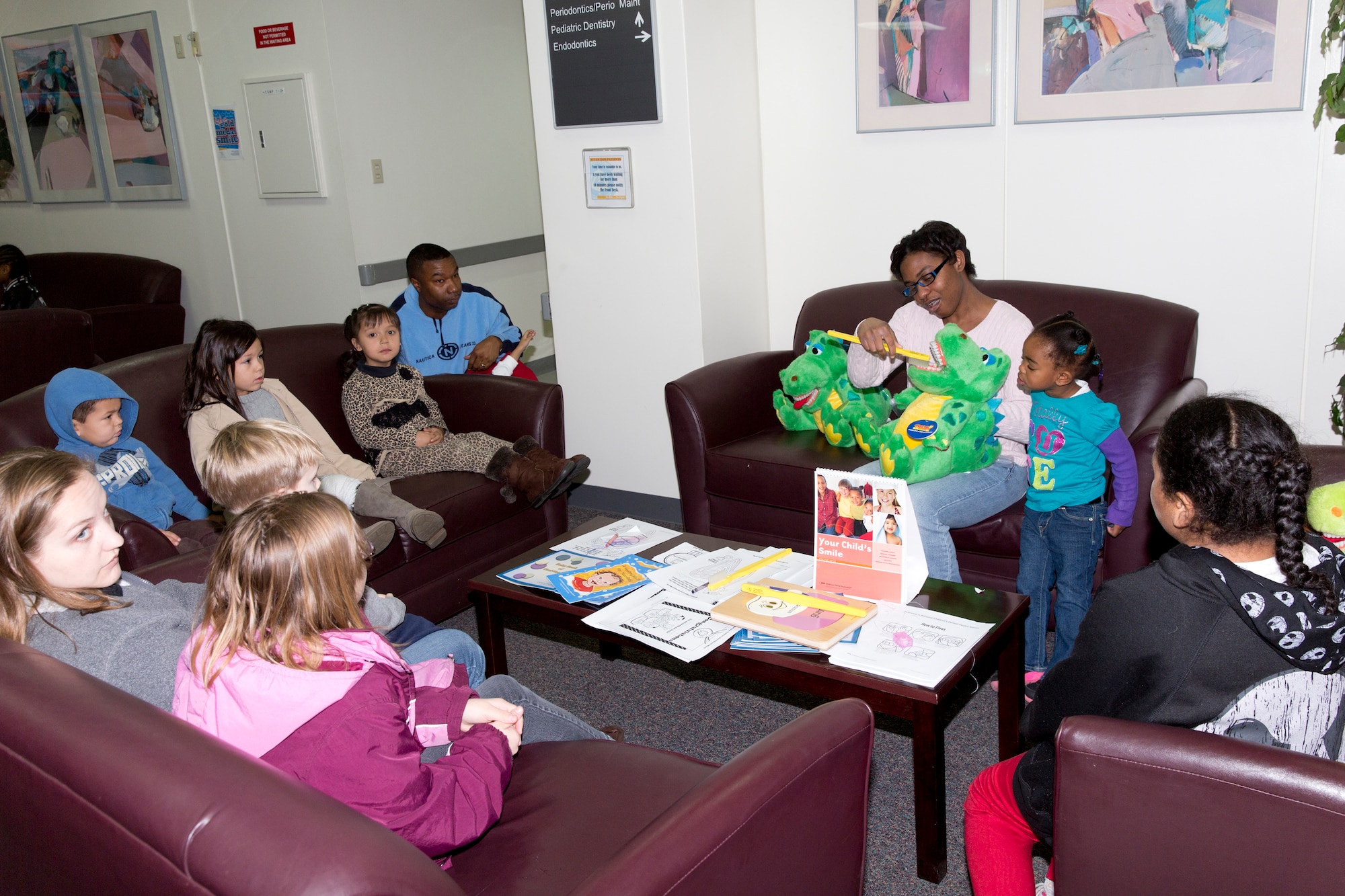 YOKOTA AIR BASE, Japan -- Staff Sgt. Deneka Davis, 374th Dental Squadron dental technician, demonstrates how to brush teeth at Yokota Dental Clinic, Feb. 2, 2013. As part of National Children's Dental Health Month, the 374 DS hosted walk-in clinic for children, including dental examinations, cleanings and education services. (U.S. Air Force photo by Osakabe Yasuo) 