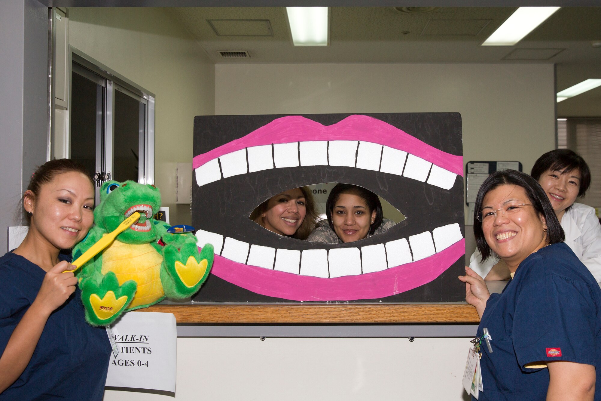 YOKOTA AIR BASE, Japan -- Yokota Dental Clinic members pose while showing off educational visual aids at the Yokota dental clinic, Feb. 2, 2013. As part of National Children's Dental Health Month, the 374th Dental Squadron hosted a walk-in clinic for children, including dental examinations, cleanings and education services to promote good oral health among the Yokota's youngest population. (U.S. Air Force photo by Osakabe Yasuo)