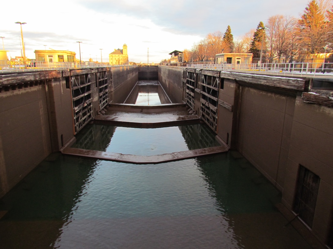 A view of the nearly empty MacArthur Lock from the top of the stop logs at the upper end.  From this angle the gate sills and gates are visible as well as one of the filling ports at the lower right side.