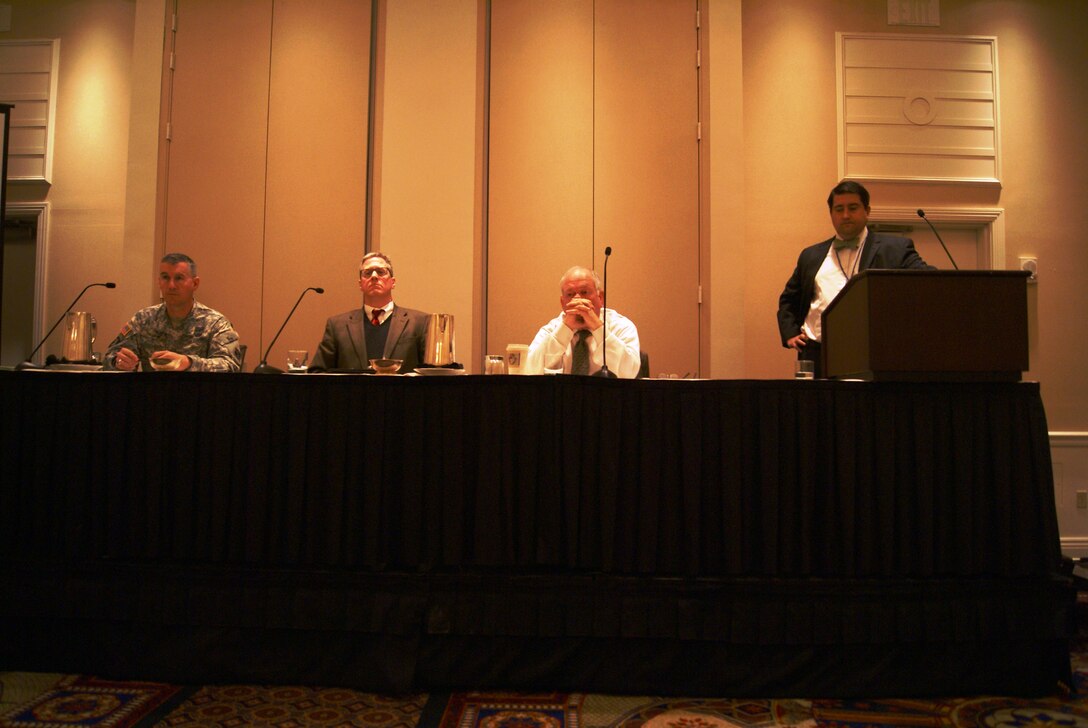 Col. Michael Teague,Tulsa District commander, Bob Portiss, Port of Catoosa director, and Steven Greetham, Chief General Counsel for the Chickasaw Nation Division of Commerce listen as panel moderator Cory Cox, Arkansas Land Commission Office addresses the audience during the Western States Land Commission Association winter meeting. 