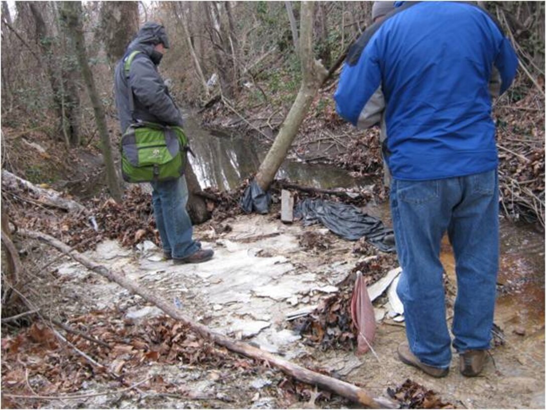 Corps representatives observing unauthorized fill material in Beaverdam Creek in Hyattsville, Maryland.