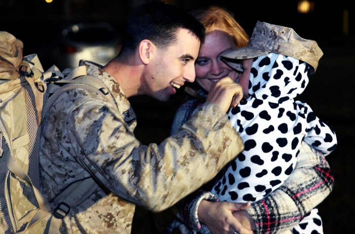 A Marine with Combat Logistics Battalion 2, 2nd Marine Logistics Group pinches the cheek of his child after returning from a nearly six-month deployment to Afghanistan to Camp Lejeune, N.C., Jan. 20, 2012. The unit set out for Helmand Province, Afghanistan, in July 2012 to perform logistical operations, assist NATO efforts to train Afghan National Security Forces, and demilitarize old military installations in the country.