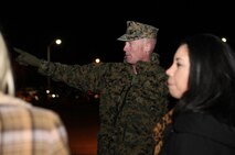 Brig. Gen. Edward D. Banta, the 2nd Marine Logistics Group commanding general, points out the direction of buses loaded with returning servicemembers during Combat Logistics Battalion 2, 2nd MLG’s homecoming celebration aboard Camp Lejeune, N.C., Feb. 1, 2013. Banta joined the throngs of families and friends who gathered to greet the servicemembers in front of the unit’s barracks early in the morning. 