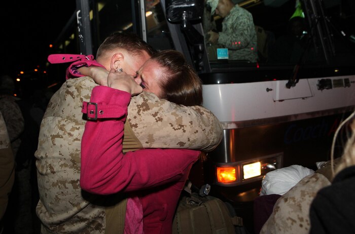 A Marine with Combat Logistics Battalion 2, 2nd Marine Logistics Group wraps his arms around a family member shortly after exiting his bus aboard Camp Lejeune, N.C., Feb. 1, 2013. Crowds of families and friends greeted the servicemembers as six buses unloaded approximately 290 personnel returning from their deployment to Afghanistan. 