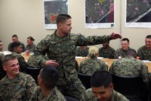 An instructor for 2nd Marine Logistics Group Corporals Course performs martial arts while addressing the Marines during a mess night aboard Camp Lejeune, N.C., Feb. 6, 2013.  Servicemembers shared experiences during the meal, which concluded a four-week course where they expanded their knowledge on military tactics, protocol and leadership. 