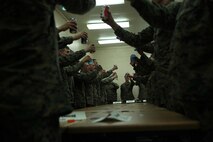 Corporals with the 2nd Marine Logistics raise their drinks during a series of toasts at their mess night aboard Camp Lejeune, N.C., Feb. 6, 2013. The toasts honored the Marines who fought before them as well as the ones by their sides. 