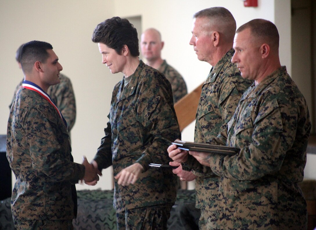 Brig. Gen. Lori Reynolds, commanding general of Marine Corps Recruit Depot Parris Island and Eastern Recruiting Region, presents awards to Marines who placed in the top 3 for each yard line at the 2013 Tri-Command Rifle and Pistol Intramural, Jan. 22. The competitors that demonstrated the professionalism to represent the Tri-Command Community and the desire to continue participating in marksmanship competitions were offered a chance to become a member of the Parris Island Rifle and Pistol Team.