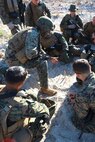 Cpl. Michael J. Kiser, a native of Montgomery, Ala., and a student at 2nd Marine Logistics Group’s Corporals Course, reviews his squad’s plan for an upcoming patrol during the class’s field training aboard Camp Lejeune, N.C., Feb. 5, 2013. The students formed three squads for the event and spent the day conducting patrols and mock ambushes to practice the small-unit tactics they learned in classes. 
