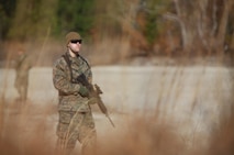 A student at 2nd Marine Logistics Group’s Corporals Course peers into the brush as his squad practices their patrol formations aboard Camp Lejeune, N.C., Feb. 5, 2013. The Corporals Course students spent four weeks learning about small-unit tactics, leadership and the Marine Corps’ traditions before conducting their final field exercise Feb. 5 – 6. 