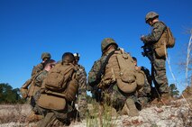 A squad of Marines with 2nd Marine Logistics Group’s Corporals Course gathers to plan for a next patrol during their training exercise aboard Camp Lejeune, N.C., Feb. 5, 2013. Three squads of Marines spent the day laying mock ambushes and conducting patrols throughout their training area, where they applied the tactics taught to them throughout the course.