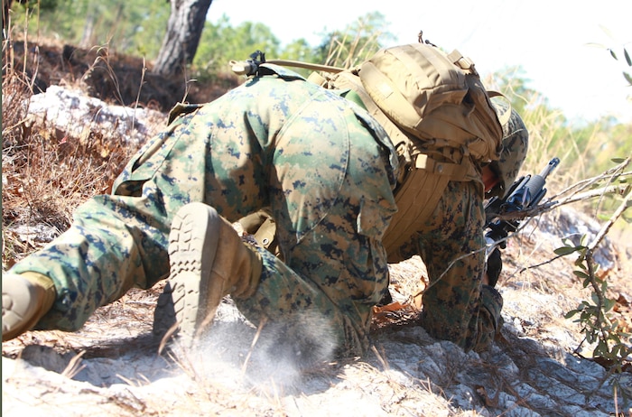 A Marine scurries out of his concealed position as his squad launches into the offensive during a training exercise held by 2nd Marine Logistics Group’s Corporals Course aboard Camp Lejeune, N.C., Feb. 5, 2013. The right side of the Marine’s squad made contact with a rival unit just prior to the engagement, which allowed the course’s students to employ the tactics they learned in the classroom. 