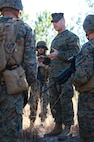 Sgt. Mathew J. Stotts, an instructor with 2nd Marine Logistics Group’s Corporals Course, debriefs his squad of students after a simulated engagement with a rival unit aboard Camp Lejeune, N.C., Feb. 5, 2013. Stotts used the engagement as a teaching tool for the Marines, who were preparing for their final field exercise scheduled for the next day.