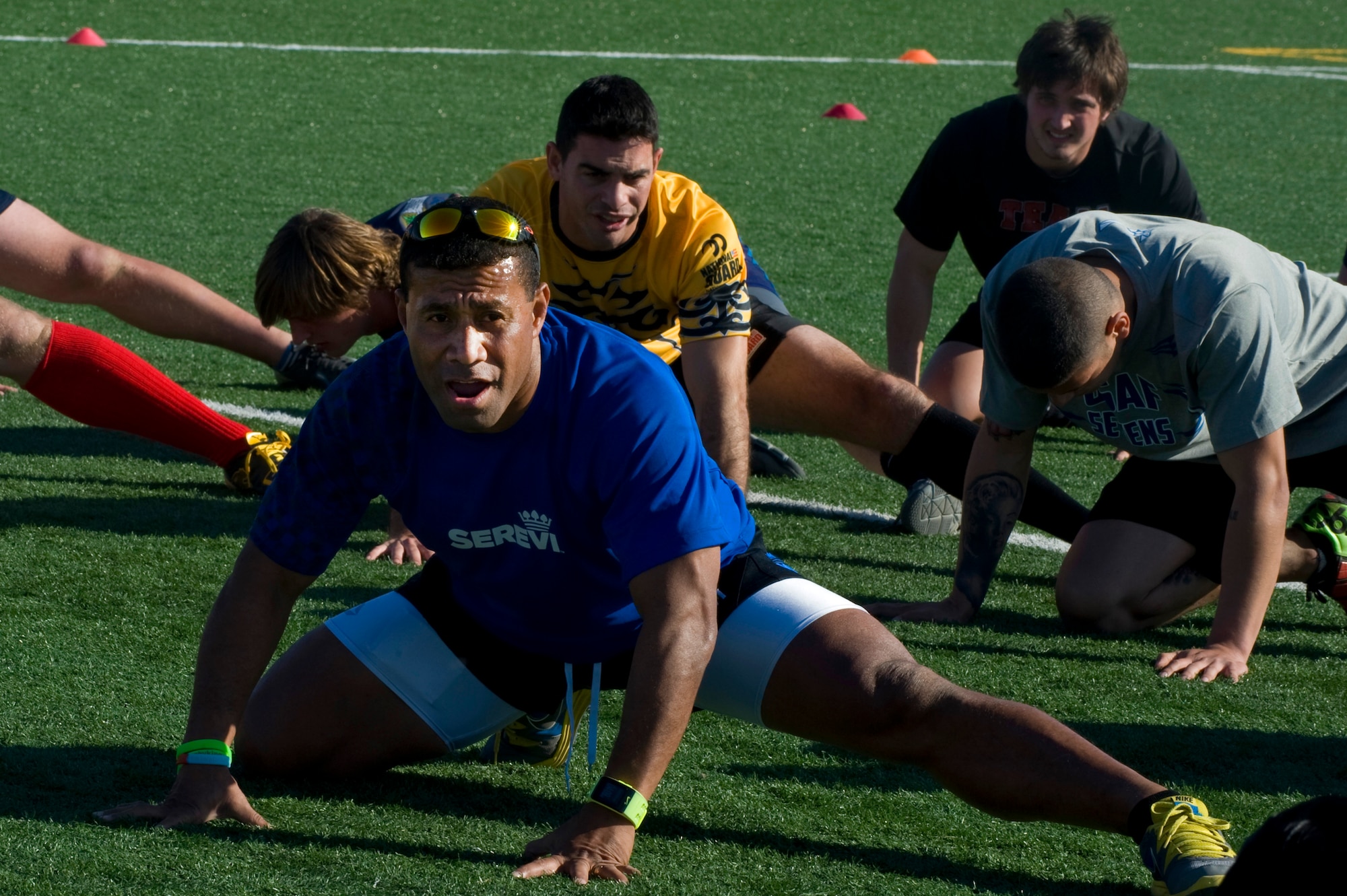 Waisale Serevi, former Fijian rugby union footballer, leads warm-up stretching during the military rugby clinic Feb. 6, 2013 at Nellis Air Force Base, Nev.  Serevi is the former number one rugby player in the world on the fifteen-a-side rugby throughout his playing career; Serevi is most notable for his achievements in rugby sevens. (U.S. Air Force photo by Senior Airman Matthew Lancaster)