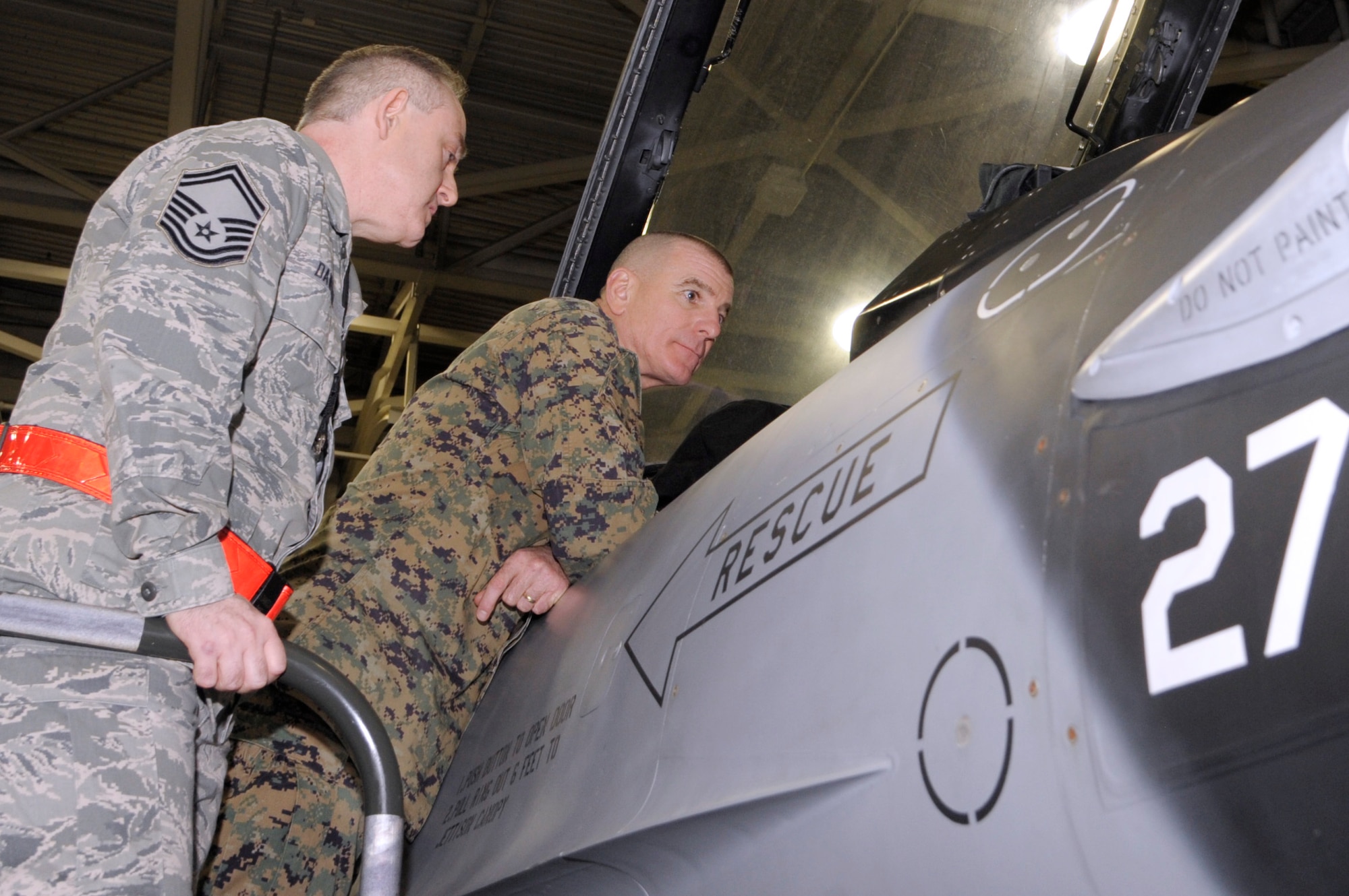 U.S. Marine Corps Sgt. Maj. Bryan Battaglia, senior enlisted advisor to the chairman of the Joint Chiefs of Staff, right, is shown operational procedures on an F-16 Fighting Falcon by U.S. Air Force Senior Master Sgt. Sean Dawson, 354th Aircraft Maintenance Unit superintendent, during a tour of Eielson Air Force Base, Alaska Jan. 30, 2013.  Battaglia visited several locations on base and held an all call with enlisted personnel at the base theater. He briefed members of the Iceman Team on the CJCS’ priorities and his philosophy on bridging the basics, total force fitness, renewing the commitment to profession of arms, all of which contribute to meeting national objectives for current and future conflicts. (U.S. Air Force Photo/Airman 1st Class Peter Reft)