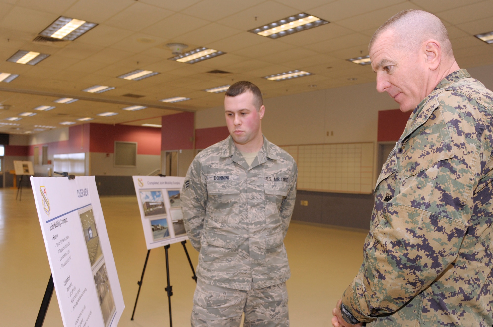 U.S. Marine Corps Sgt. Maj. Bryan Battaglia, senior enlisted advisor to the chairman of the Joint Chiefs of Staff, right, meets with U.S. Air Force Senior Airman Matthew Donnini, 354th Logistics Readiness Squadron logistics planner, at the Stevens Joint Mobility Complex during a tour of Eielson Air Force Base, Alaska Jan. 30, 2013.  Battaglia was briefed about the JMC’s history, passenger capacity and joint mission capabilities. Battaglia serves as the principal military advisor to the Chairman and the Secretary of Defense on all matters involving joint and combined total force integration, utilization, health of the force and joint development for enlisted personnel. (U.S. Air Force Photo/Airman 1st Class Peter Reft)
