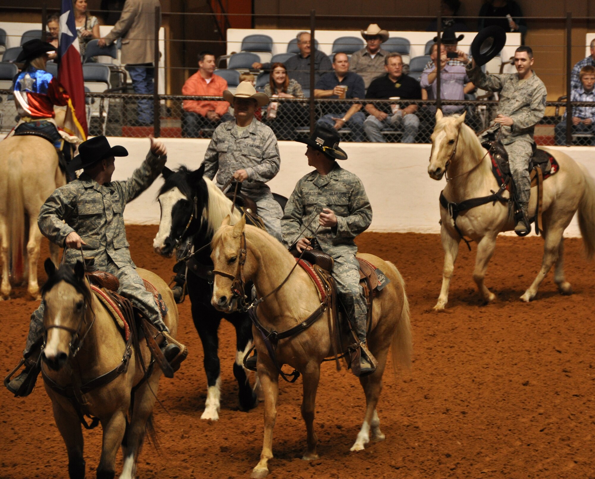 These Air Force Reservists, Colonel Kurt Gallegos, Master Sergeant Lindsay Estell, Master Sergeant Karl Freund and 1st Lieutenant Chad Lutz, stationed at Naval Air Station Fort Worth Joint Reserve Base, Texas, participated in the this year's Fort Worth Stock Show and Rodeo Military Appreciation Day's Grand Entry Feb. 4. Col. Gallegos is the former 301st Operations Group commander. MSgt Estell is a Medical Technician  with the 301st Medical Squadron. MSgt Freund is a Quality Assurance Inspector in the 301st Aircraft Maintenance Group and 1st Lt. Lutz is an F-16 pilot in the 457th Fighter Squadron. The Grand Entry signifys the start of each rodeo. (U.S. Air Force photo/Master Sgt. Julie Briden-Garcia)