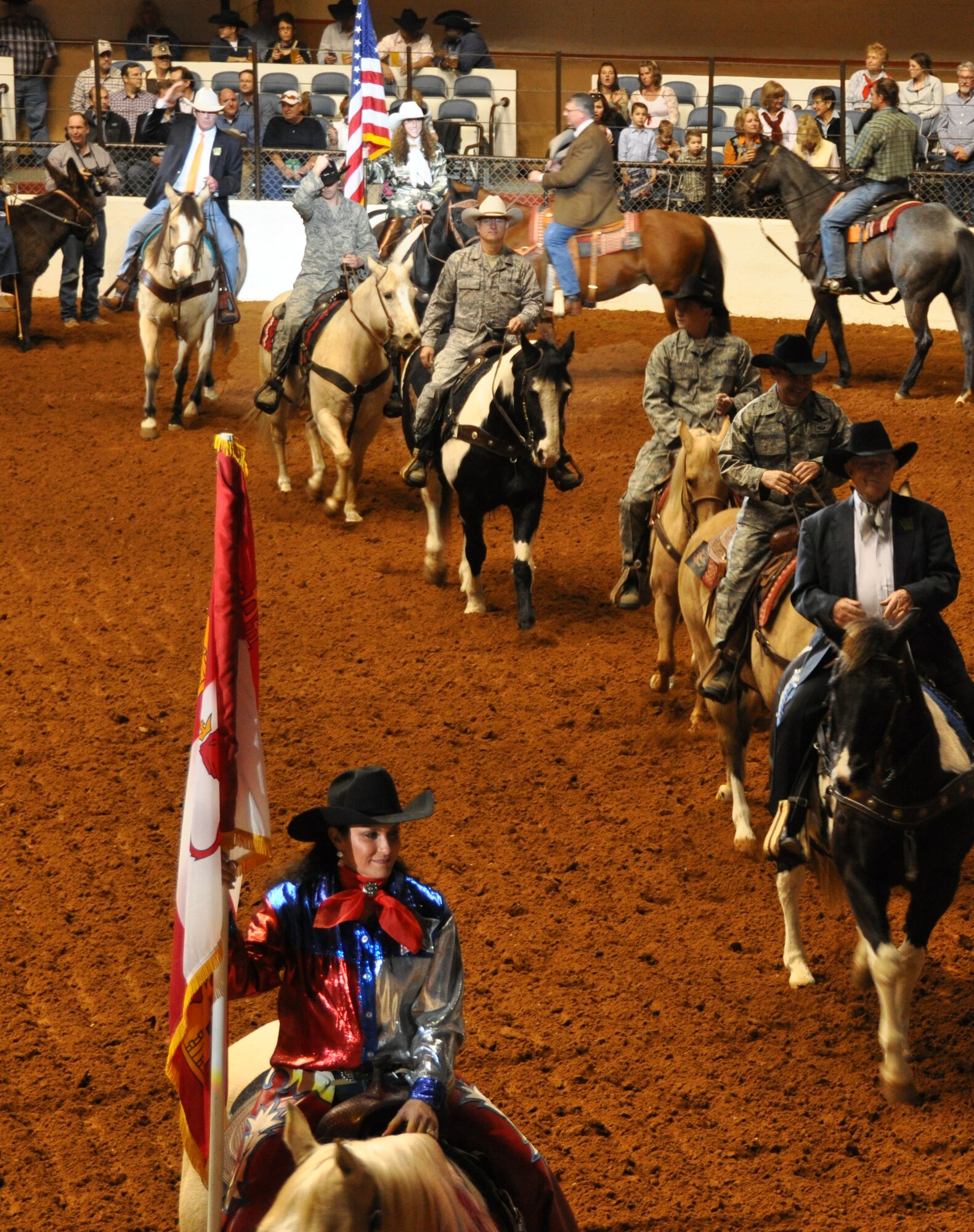 These Air Force Reservists, Colonel Kurt Gallegos, Master Sergeant Lindsay Estell, Master Sergeant Karl Freund and 1st Lieutenant Chad Lutz, stationed at Naval Air Station Fort Worth Joint Reserve Base, Texas, participated in the this year's Fort Worth Stock Show and Rodeo Military Appreciation Day's Grand Entry Feb. 4. Col. Gallegos is the former 301st Operations Group commander. MSgt Estell is a Medical Technician  with the 301st Medical Squadron. MSgt Freund is a Quality Assurance Inspector in the 301st Aircraft Maintenance Group and 1st Lt. Lutz is an F-16 pilot in the 457th Fighter Squadron. The Grand Entry signifys the start of each rodeo. (U.S. Air Force photo/ Master Sgt. Julie Briden-Garcia)