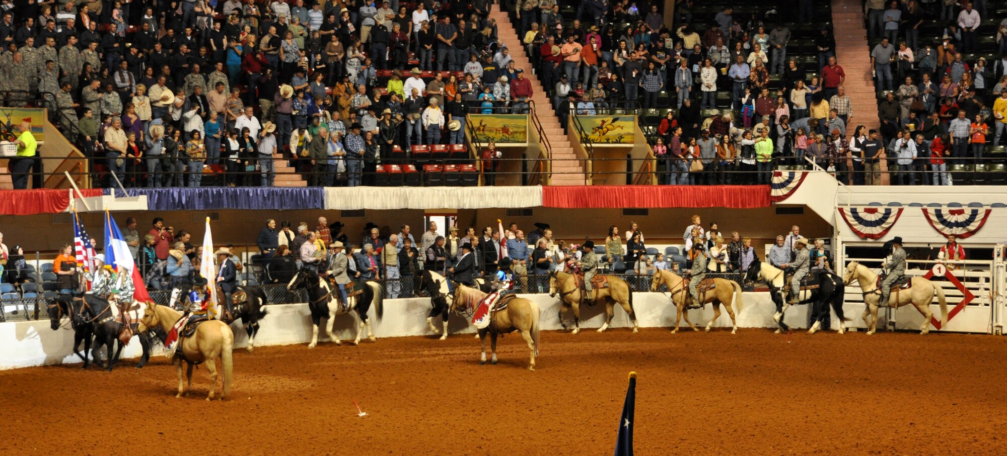 These Air Force Reservists stationed at Naval Air Station Fort Worth Joint Reserve Base, Texas, participated in the this year's Fort Worth Stock Show and Rodeo Military Appreciation Day's Grand Entry Feb. 4. The Grand Entry signifys the start of each rodeo. (U.S. Air Force photo/Master Sgt. Julie Briden-Garcia)
