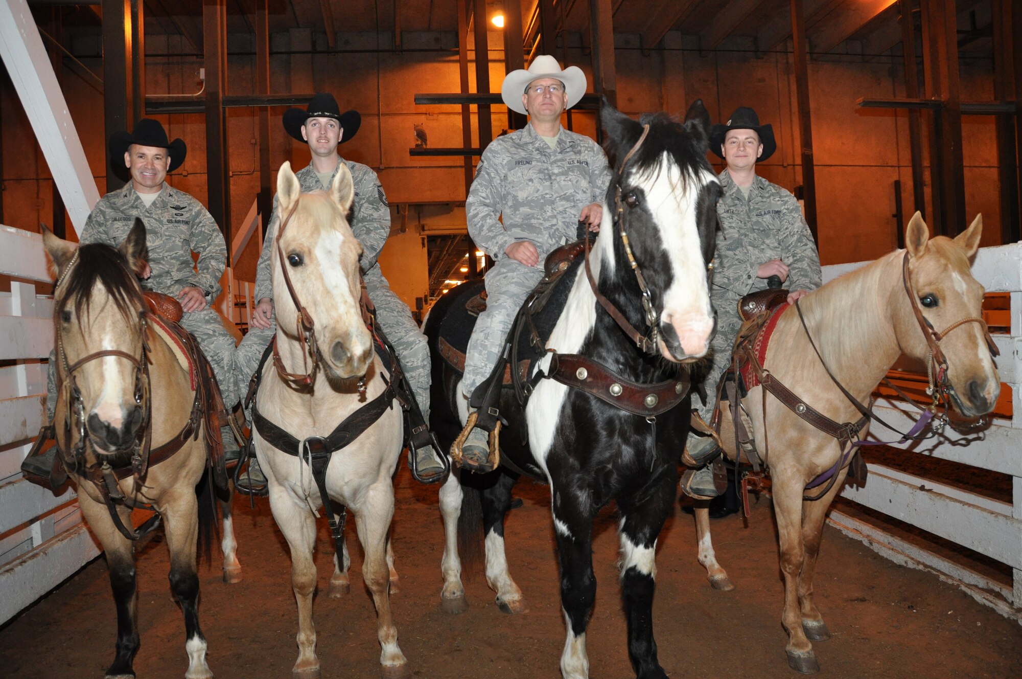 These Air Force Reservists, Colonel Kurt Gallegos, Master Sergeant Lindsay Estell, Master Sergeant Karl Freund and 1st Lieutenant Chad Lutz, stationed at Naval Air Station Fort Worth Joint Reserve Base, Texas, participated in the this year's Fort Worth Stock Show and Rodeo Military Appreciation Day's Grand Entry Feb. 4. Col. Gallegos is the former 301st Operations Group commander. MSgt Estell is a Medical Technician  with the 301st Medical Squadron. MSgt Freund is a Quality Assurance Inspector in the 301st Aircraft Maintenance Group and 1st Lt. Lutz is an F-16 pilot in the 457th Fighter Squadron. The Grand Entry signifys the start of each rodeo. (U.S. Air Force photo/ Master Sgt. Julie Briden-Garcia)
