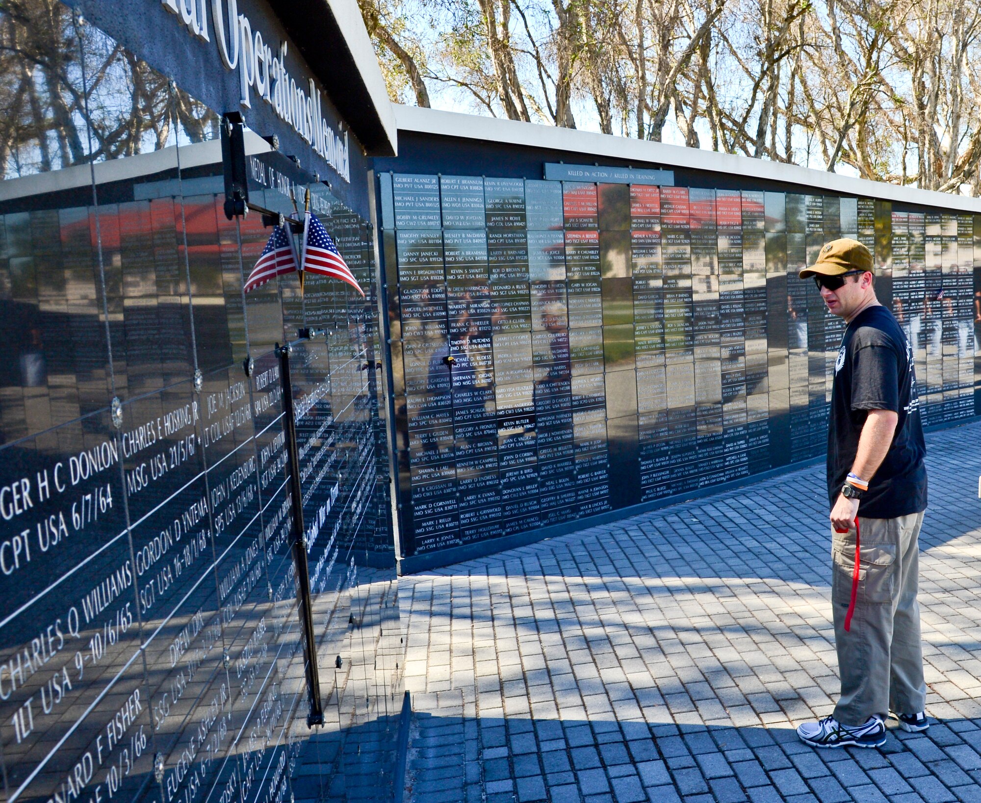Master Sgt. John Hickman, 18th Flight Test Squadron first sergeant, scans the names of fallen heroes on the U.S. Special Operations Command memorial wall at MacDill Air Force Base Fla., Feb. 8, 2013. Hickman’s journey began on the Emerald Gulf Coast, where he and fifteen other members of the Air Commandos began their 450-mile march which ended at MacDill AFB, to honor five Air Commandos who were killed in 2012. (U.S. Air Force photo by Senior Airman Adam Grant/Released)     