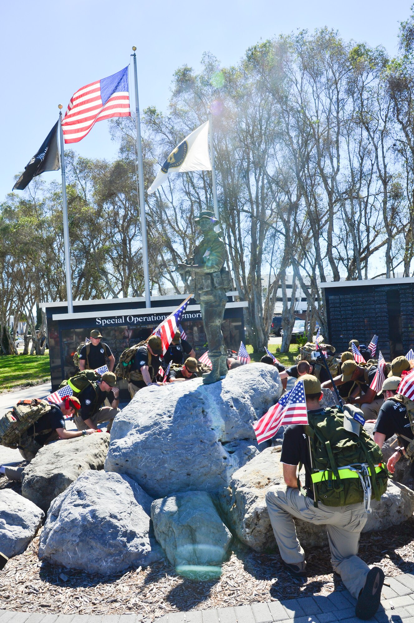 Sixteen Airmen from Hurlburt Field, Fla., kneel for a moment of silence upon completion of a 450-mile march at MacDill Air Force Base Fla., Feb. 8, 2013. The march honored five Air Commandos who were killed in 2012. (U.S. Air Force photo by Senior Airman Adam Grant/Released)    