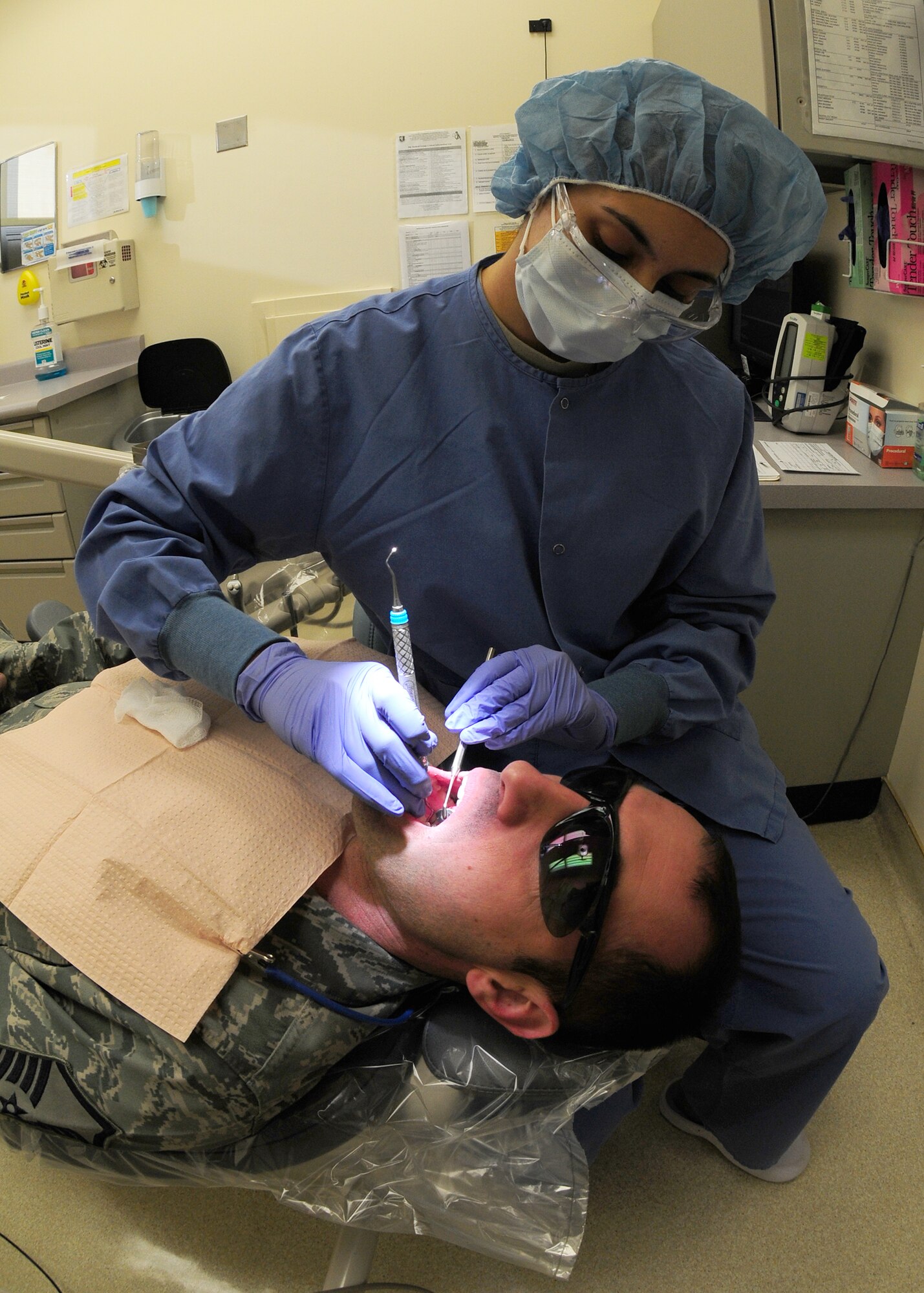 Airman 1st Class Ashley Wall, 9th Aerospace Medical Dental Squadron oral prophylaxis assistant, performs an annual cleaning exam at the dental clinic on Beale Air Force Base Calif., Feb. 8, 2013. Wall was the 9th Medical Group 2012 Airman of the Year. (U.S. Air Force photo by Senior Airman Allen Pollard/Released)