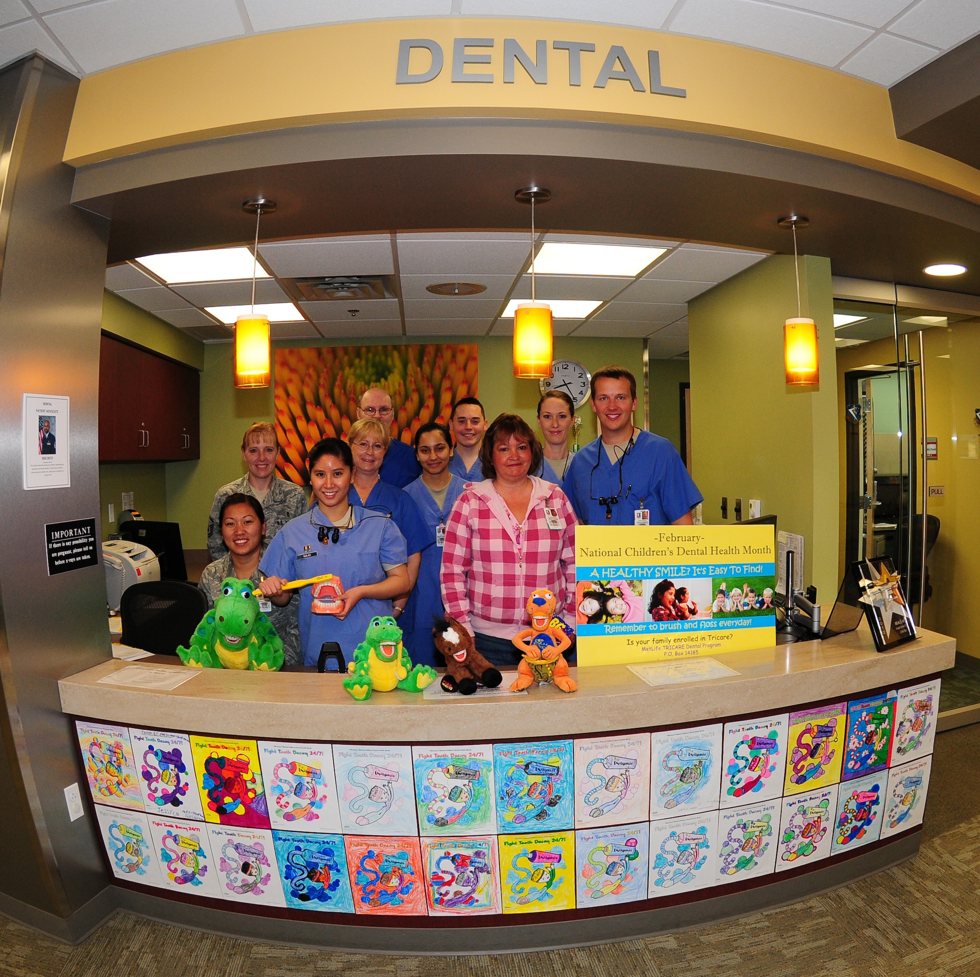Members of the 9th Aerospace Medical Dental Squadron pose for a photo at the front desk of the clinic on Beale Air Force Base Calif., Feb. 8, 2013. February is National Children's Dental Health Month. (U.S. Air Force photo by Senior Airman Allen Pollard/Released)