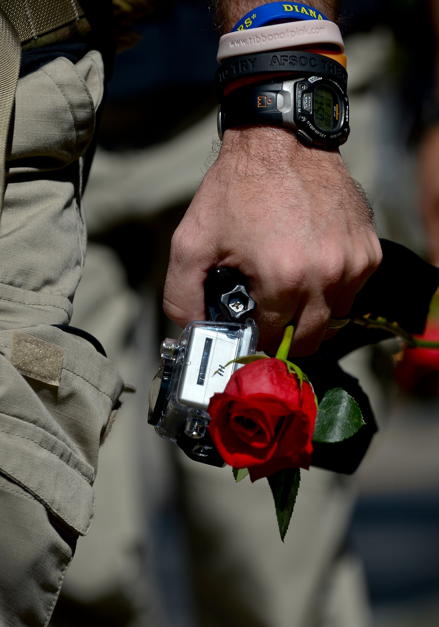 An Airman carries a rose given to him by a Patriot Guard Rider as he completes a 450-mile march in Tampa Fla., Feb. 8, 2013. Sixteen Airmen participated in the march which started on Feb. 3., at Hurlburt Field and ended at the U.S. Special Operations Command memorial at MacDill Air Force Base, Fla. (U.S Air Force photo by Senior Airman Melissa Paradise/Released)