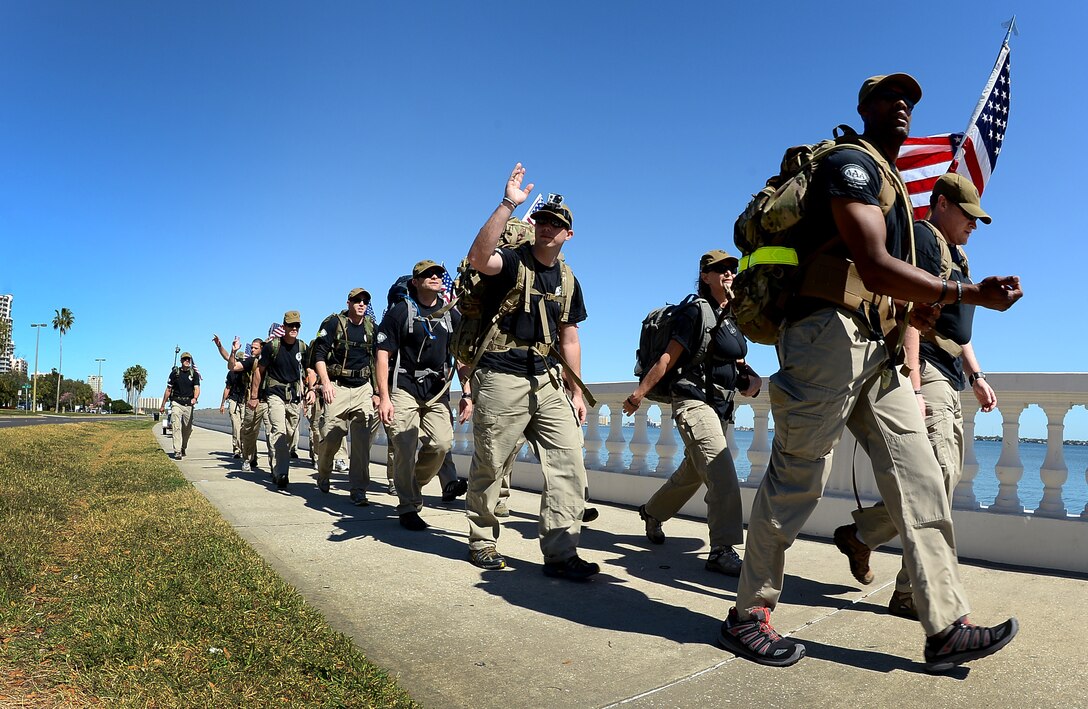 Air Commandos from Hurlburt Field, Fla., wave to passing cars during the last leg of a 450-mile march in honor of five fallen Air Commandos, Tampa, Fla., Feb. 8, 2013. Four teams from the 319th Special Operations Squadron, the 34th SOS, the 18th Flight Test Squadron, and the 25th Intelligence Squadron completed the march in six days. (U.S. Air Force photo by Airman 1st Class David Tracy/Released)