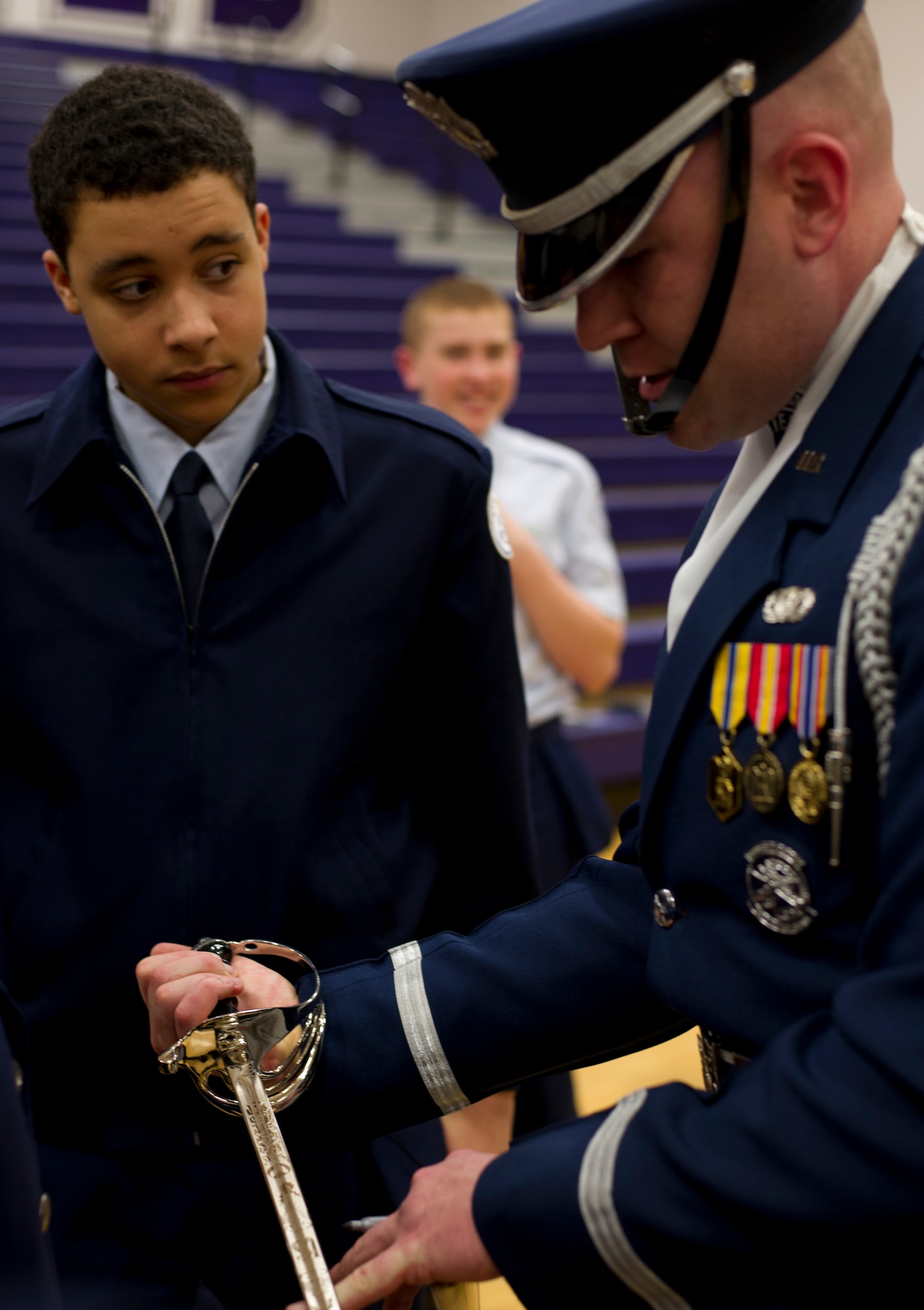 Capt. Alexander Stanton, U.S. Air Force Honor Guard Drill Team commander, explains the markings on his saber to AF JROTC students of Battlefield High School on Feb. 6, 2013 in Haymarket, Va. The performance was Stanton’s final performance with the Drill Team. (U.S. Air Force photo/ Senior Airman Bahja Joi Jones)