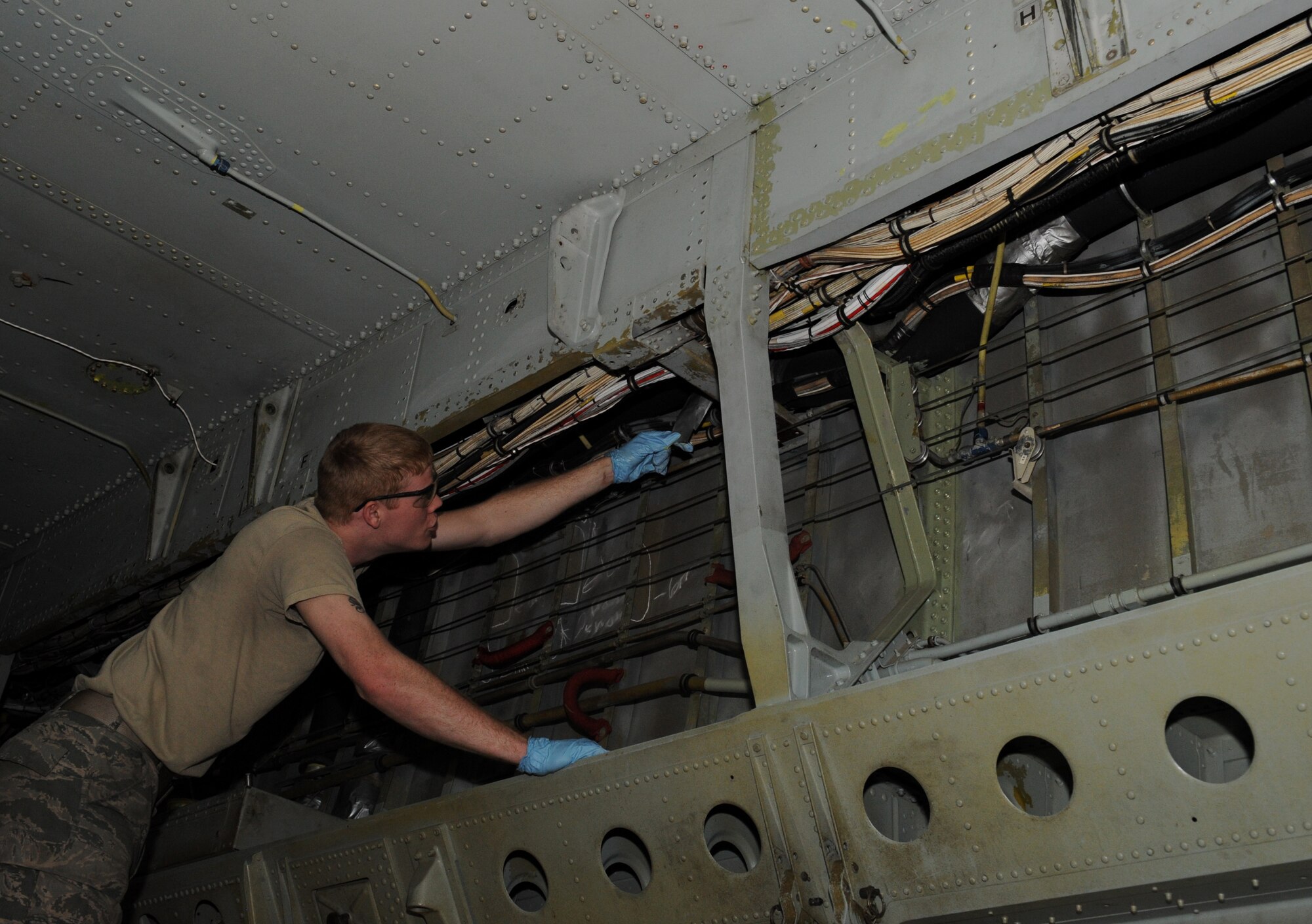 Airman 1st Class Shelby Bates, 2nd Maintenance Squadron Fabrication Flight, looks for corrosion inside a B-52H Stratofortress on Barksdale Air Force Base, La., Feb. 8. When corrosion is found on a B-52, 2 MXS Fab Flight Airmen will grind the corroded area to bare metal and place a primer over it to prevent further corrosion. (U.S. Air Force photo/Airman 1st Class Benjamin Gonsier)
